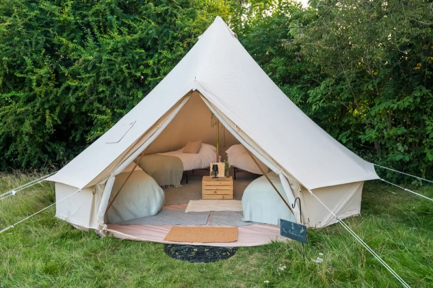 Four real beds made up inside a Luxury bell tent