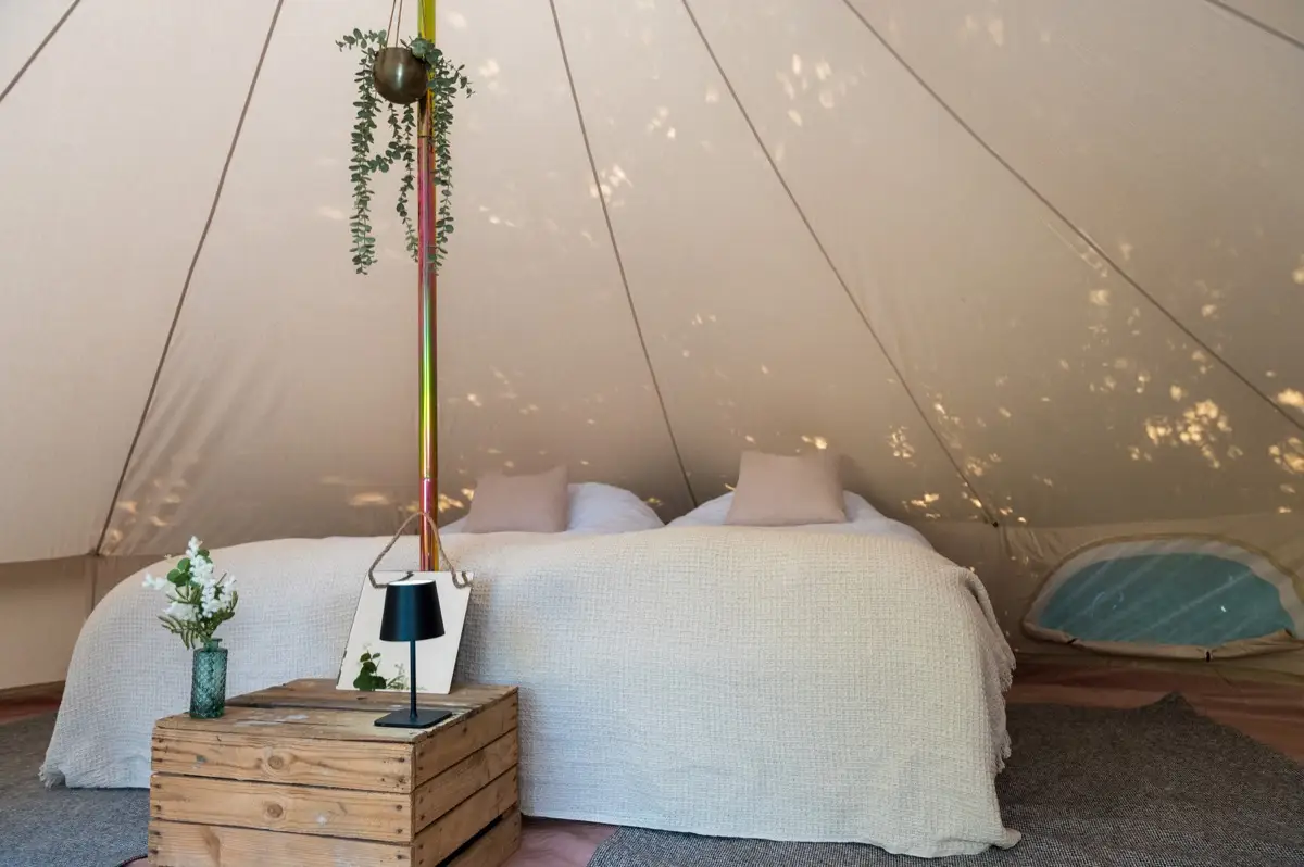 Two real beds pushed together as a king with a king duvet in a Luxury bell tent
