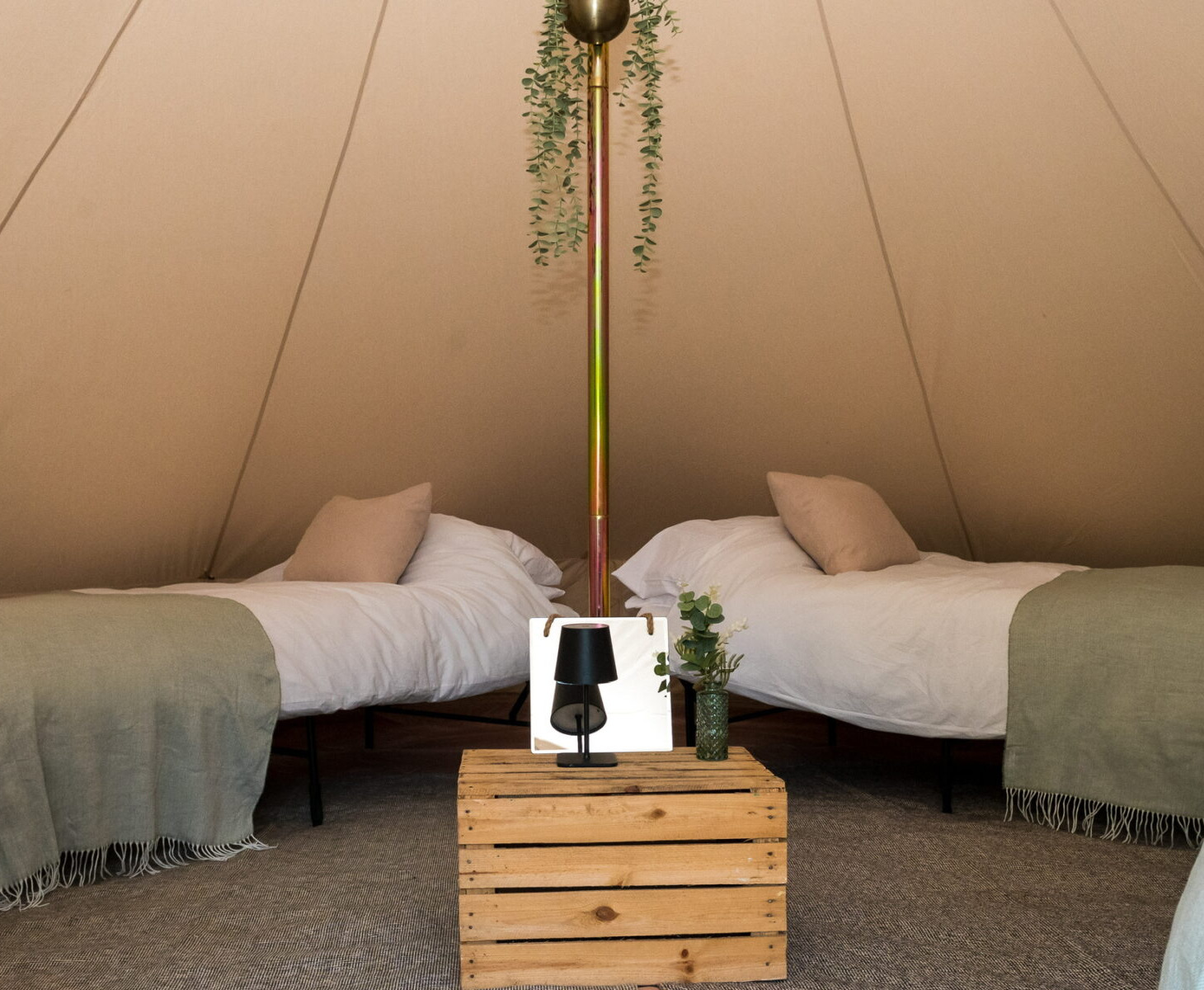 Two single real beds made up in a styled bell tent